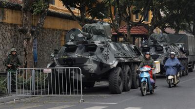 Motorists pass by army vehicles outside the Melia Hotel where North Korea leader Kim Jong-un is expected to stay. AP Photo