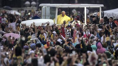 Pope Francis waves to the crowd after conducting mass at the Rizal Park in Manila, Philippines, on January 18, 2015. Getty Images