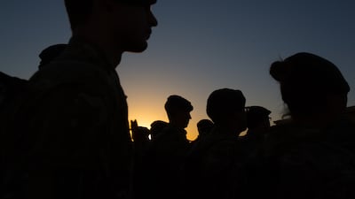 British troops attend a sunset flag-lowering and end-of-mission ceremony at Kandahar airfield in 2014