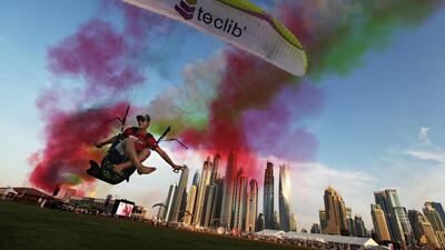 Paraguilder Ragolski Francois, 28, of France takes a practice run and leap just after an aerobatic team raced by at the World Air Games in Dubai. Jon Gambrell / AP Photo