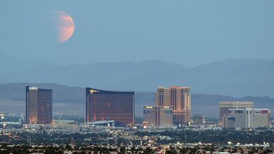 An eclipsed supermoon rises behind the Las Vegas Strip in Las Vegas, Nevada. Ethan Miller / Getty Images / AFP