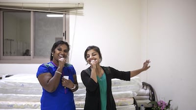 School bus assistants Bijimol Chalamma, left, and Kopila Ghimire Korki practise at Al Quoz women’s camp in Dubai. Mona Al Marzooqi / The National