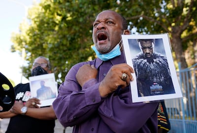Najee Ali, director of Project Islamic Hope, leads a 'Wakanda Forever' salute during a news conference to celebrate the late actor Chadwick Boseman. AP Photo
