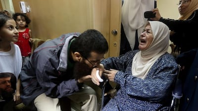 Khader Adnan, a Palestinian prisoner who staged a 56-day hunger strike while being detained for a year without charge by Israeli authorities, kisses his mother as he arrives in the West Bank village of Arraba after his release early on July 12, 2015. Jaafar Ashtiyeh/AFP Photo