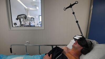 A patient wears a virtual reality headset before undergoing hypnotherapy in Strasbourg. Frederick Florin / AFP
