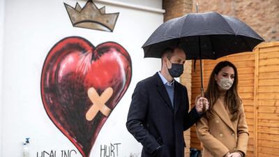 Prince William and Catherine, Duchess of Cambridge talk with members of the ambulance service in the wellbeing garden during a visit to Newham Ambulance Station in east London. AFP