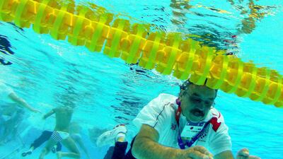 Croatia coach Ratko Rudic swims after jumping in the pool to celebrate his team's 8-6 victory over Italy during the men's water polo gold medal match. Julio Cortez/AP Photo