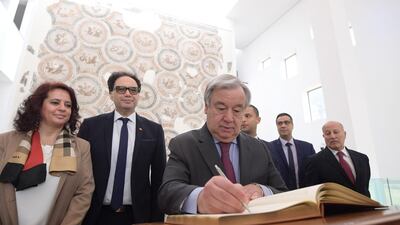 UN Secretary-General Antonio Guterres signs a book in memory of victims of the 2015 attack on the Bardo National Museum in Tunis. AFP