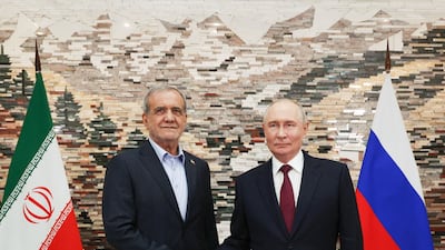 Iranian President Masoud Pezeshkian, left, meets Russia's President Vladimir Putin during a meeting at the Shanghai Cooperation Organisation summit in Bishkek. AFP