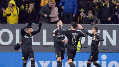 Dortmund players celebrate their third goal against Augsburg. EPA