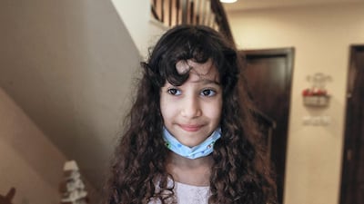 Seven-year-old Fatima Alzaabi proudly shows a paper skirt she created . Victor Besa /The National