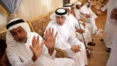 Awana Ahmad Al Mosabi, left, has asked motorists not to use mobile devices such as BlackBerry smartphones while driving following the death of his talented footballer son.