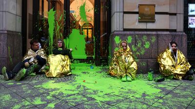 Activists from Letzte Generation (Last Generation) sit outside Hotel Adlon in Berlin, the venue for the World LNG Summit, after paint was thrown at entrance. Reuters