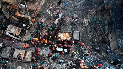 Rescue personnel carry the body of a victim after a fire broke out in Dhaka. AFP