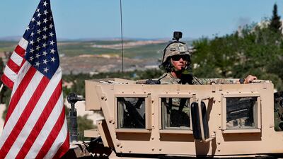A US soldier sits in his armoured vehicle in Manbij, north Syria. Hussein Malla / AP