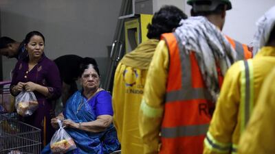 Ramadan fridges team gets busy distributing meals to labourers. Among the volunteers is Krishna Bhatia, in blue, the 87-year-old woman who donates food and distributes around camps and in a network of fridges across Dubai. Chris Whiteoak for The National