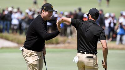 International team player Im Sung-jae of South Korea, left, with teammate Adam Hadwin of Canada in Melbourne. AFP