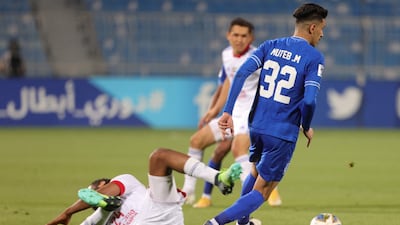 Hilal defender Muteb al-Mufarrij dribbles past Sharjah midfielder Majid Rashid.