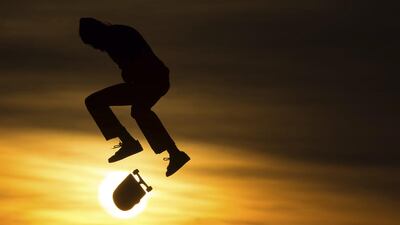 A skateboarder performs during sunset in Berlin, Germany. Sebastian Gollnow / dpa via AP