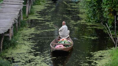 Kashmiri Muslims gather with their boats laden with vegetables at the floating vegetable market on Dal Lake at dawn in Srinagar. Sajjad Hussain / AFP