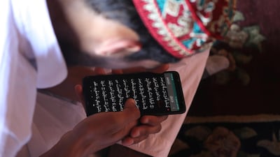 A Kashmiri Muslim boy recites the Quran from the mobile phone on the first day of fasting month of Ramadan inside Jamia Masjid (Kashmir's Grand Mosque) in Srinagar,the summer capital of Indian Kashmi. EPA