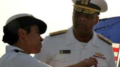 Rear Admiral Michelle Howard, left, discusses the changeover with the commander of the new strike group, Rear Admiral Sinclair Harris.