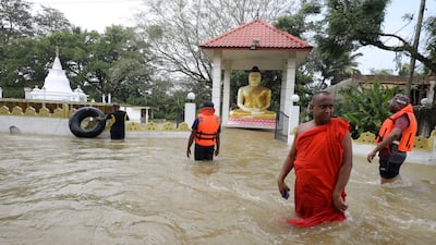 A Buddhist monk stands near his flooded temple in a suburb of Colombo. EPA