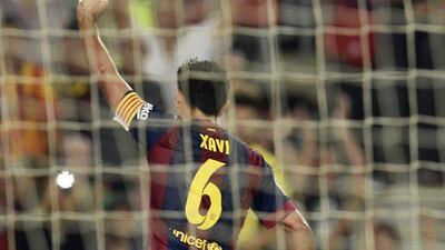Barcelona's Xavi Hernandez celebrates after scoring a goal against Eibar in his side's 3-0 La Liga victory at the Camp Nou on Saturday. Lluis Gene / AFP / October 18, 2014