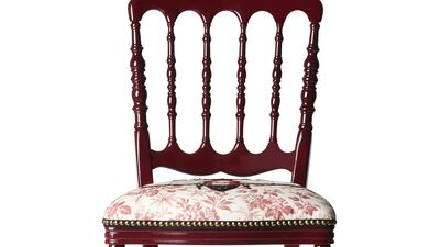 Chairs are wooden and high-backed, with lacquered frames and padded seats displaying traditional Gucci motifs, from the Staffordshire dog and roaring tiger to moths, flowers and bees. Courtesy Gucci