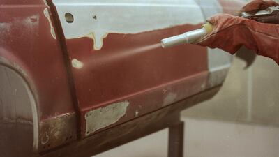 Alidu works on a vintage car inside the blasting cabinet.