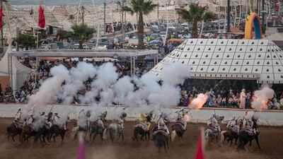 A troupe charges and fires their rifles during Tabourida, a traditional horse riding show also known as Fantasia, in the coastal town of El Jadida, Morocco.