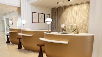 Guests check in at gold-brushed reception desks