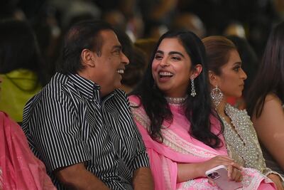 Isha Ambani, executive director, Reliance Retail Ventures Limited, with her father Mr Ambani. AFP