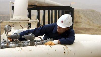 A worker checks an oil pipe gauge in Tawke oil field near Dahuk in the semiautonomous Kurdish region in northern Iraq, 400km north of Baghdad.