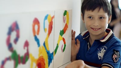Young artist Thanderbee Vislykh was only too happy to show off works he and other children had hanging at The Galleria Mall on Al Maryah Island on Tuesday. Delores Johnson / The National