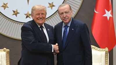 Turkish President Recep Tayyip Erdogan, right, greets US President Donald Trump at an airbase near Ankara. AFP
