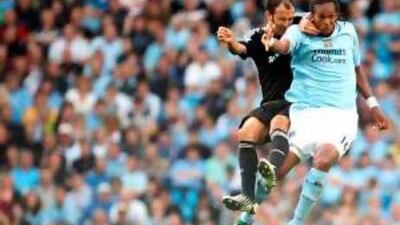Manchester City's Jo (right) and Ricardo Carvalho of Chelsea jump for the ball during Saturday's game.