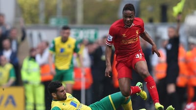 Liverpool's Raheem Sterling skips past a Norwich City defender during their Premier League match at Carrow Road in Norwich, England, on April 20, 2014. Kieran Galvin / EPA