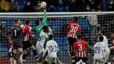 Real Madrid goalkeeper Thibaut Courtois leaps to save a high ball. AP
