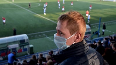 A supporter of FC Minsk, wears a facemask for protection. AFP