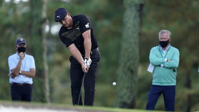 Bryson DeChambeau chips on the seventh hole. EPA