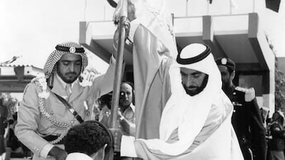 Sheikh Zayed and Sheikh Khalifa bin Zayed raise a flag at the graduation ceremony of the first batch of officers of the Zayed Military Academy in Al Ain on April 10, 1973.
