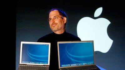 Mr Jobs holds a new 12-inch Apple G4 Powerbook laptop computer, left, and a G4 Powerbook after addressing the Macworld Conference and Expo in San Francisco, 2003. Reuters