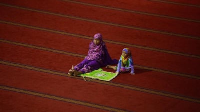 An Indonesian woman and child attend prayers on the third night of the holy month of Ramadan at the Istiqlal grand mosque in Jakarta. Adek Berry / AFP