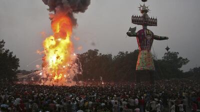 People watch as an effigy of the ten headed demon King Ravana is burnt during the Hindu festival of Dussehra in the northern Indian city of Amritsar, India. Munish Sharma / Reuters