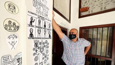 Dubai artist Abdulla Lutfi with some of his works. Chris Whiteoak / The National