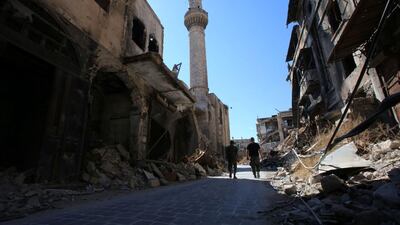 Syrian government soldiers walk in the damaged al-Farafira souk in the government-held side of Aleppo's historic city centre on September 16, 2016. After five years of war, Aleppo's historic city centre, a UNESCO-listed World Heritage site home to an imposing citadel, is a makeshift military barracks. Youssef Karwashan / AFP