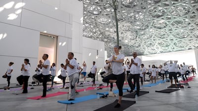 The International Day of Yoga is marked with an event at Louvre Abu Dhabi. Ryan Lim for The National