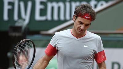 Roger Federer reacts during his loss to Ernests Gulbis at the French Open on Sunday. Pascal Guyot / AFP / June 1, 2014