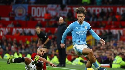 Manchester United's Sofyan Amrabat, left, duels with Manchester City's Jack Grealish. Reuters